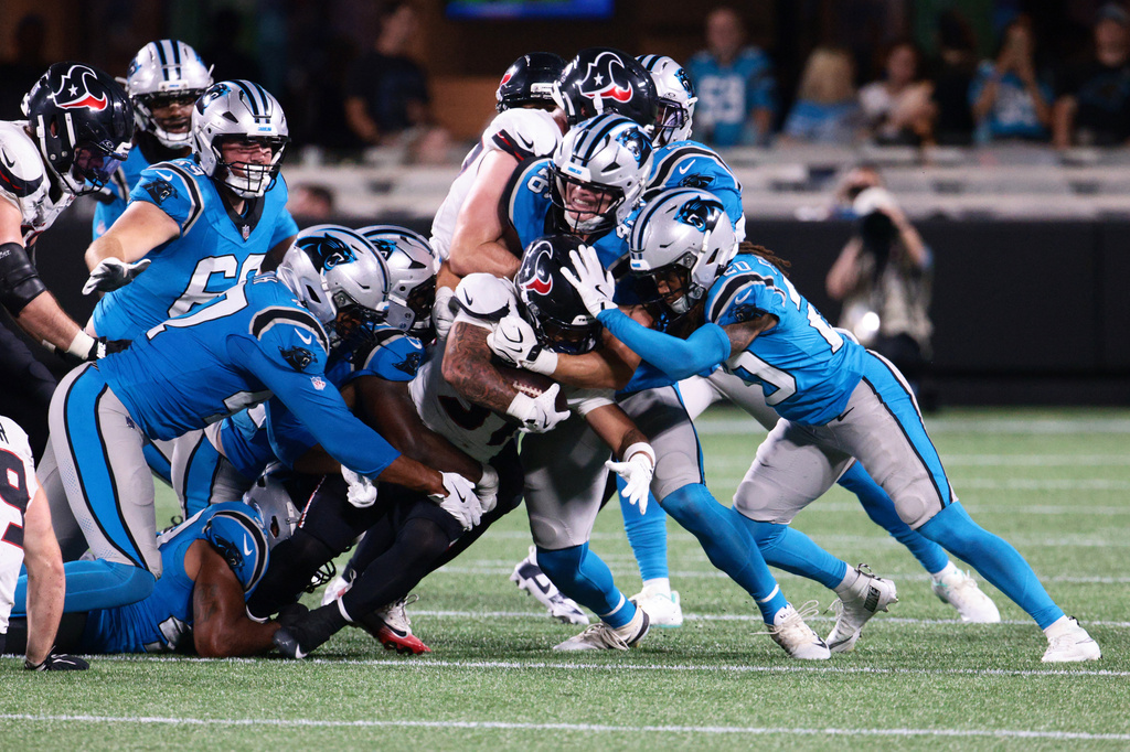 Houston Texans running back Deuce Vaughn is tackled by the Carolina Panthers during the second half of an NFL preseason football game, Friday, Aug. 28, 2026, in Charlotte, N.C. (AP Photo/Scott Kinser)