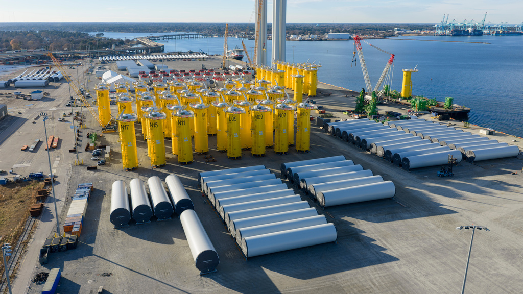 Wind turbine bases, generators and blades are positioned along with support ships at The Portsmouth Marine terminal at the staging area for Dominion Energy's wind turbine project Monday Dec. 22, 2025, in Portsmouth, Va. (AP Photo/Steve Helber)