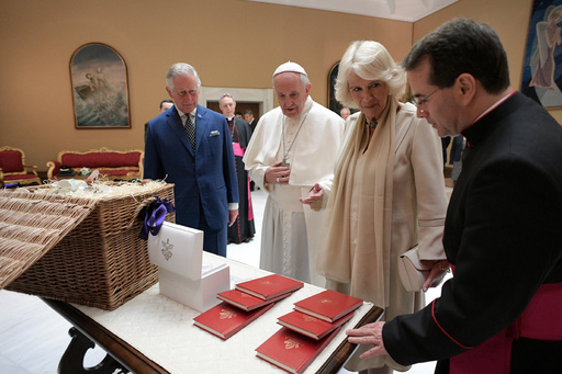 FILE -Pope Francis exchanges gifts with Britain's Prince Charles and his wife Camilla, Duchess of Cornwall, during a private audience at the Vatican, April 4, 2017. (L'Osservatore Romano/Pool Photo via AP, File) FILE -Pope Francis exchanges gifts with Britain's Prince Charles and his wife Camilla, Duchess of Cornwall, during a private audience at the Vatican, April 4, 2017. (L'Osservatore Romano/Pool Photo via AP, File)
