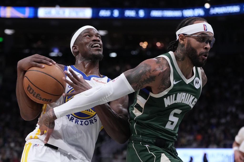 Golden State Warriors' Jimmy Butler III drives past Milwaukee Bucks' Gary Trent Jr. during the first half of an NBA basketball game Thursday, Oct. 30, 2025, in Milwaukee. (AP Photo/Morry Gash)