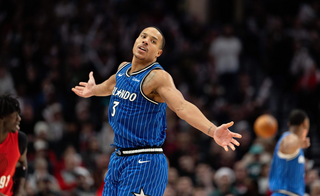 Orlando Magic guard Desmond Bane reacts to the made shot against the Portland Trail Blazers during the second half of an NBA basketball game Tuesday Dec. 23, 2025, in Portland, Ore. (AP Photo/Howard Lao)