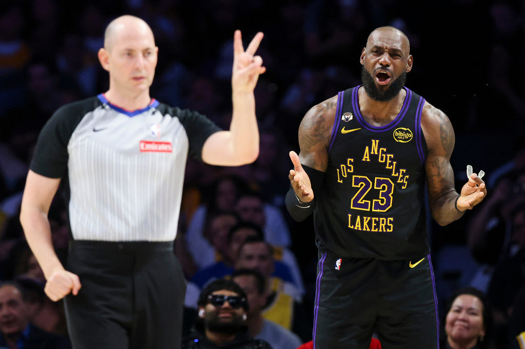 Los Angeles Lakers forward LeBron James (23) reacts towards the referee, front left, after a foul call during the second half against the Phoenix Suns of an NBA basketball game, Friday, April 10, 2026, in Los Angeles. (AP Photo/Jessie Alcheh)
