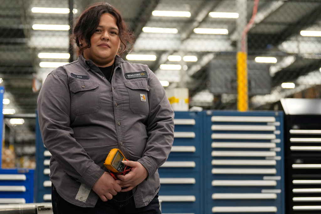 Maintenance technician Liz Cardenas poses for a photo at a training area in a Walmart distribution center Thursday, Sept. 25, 2025, in Bentonville, Ark. (AP Photo/Charlie Riedel)