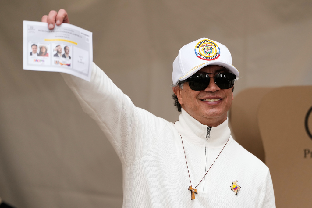 Colombian President Gustavo Petro shows a ballot during the runoff election in Bogota, Colombia, Sunday, June 21, 2026. (AP Photo/Fernando Vergara)