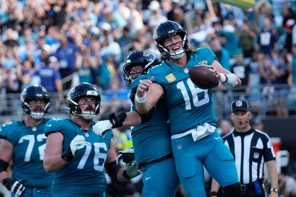 Jacksonville Jaguars quarterback Trevor Lawrence (16) celebrates a touchdown run during the second half of an NFL football game against the Jacksonville Jaguars, Sunday, Nov. 16, 2025, in Jacksonville, Fla. (AP Photo/John Raoux)
