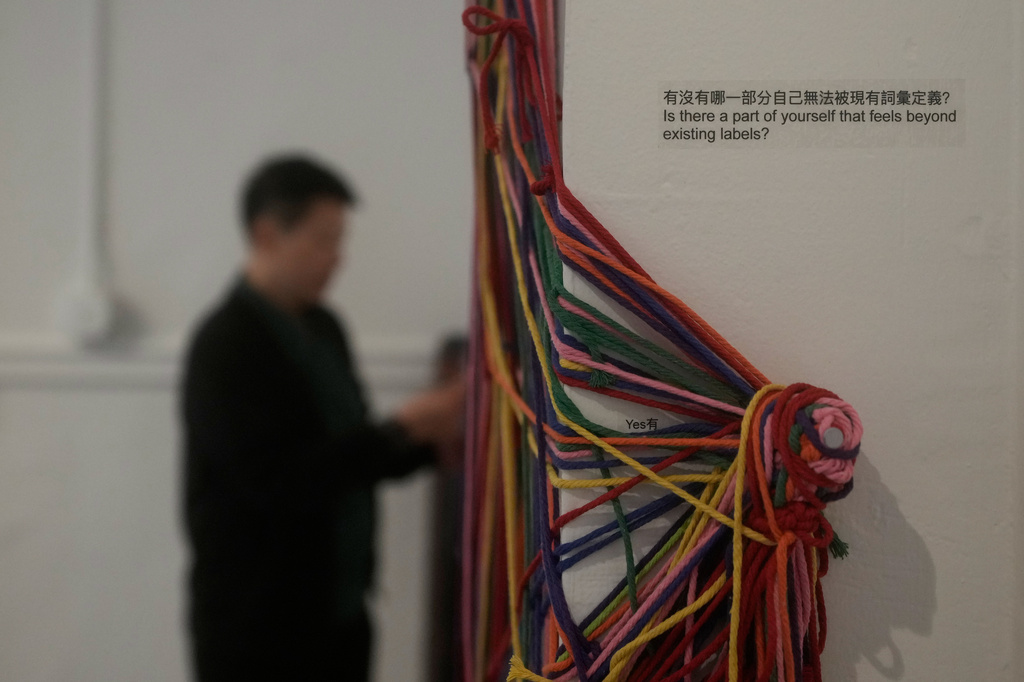 OUT Museum founder Xiangqi Chen looks toward "Collective Notation," an interactive installation displayed at the Chinatown museum, Monday, June 22, 2026, in San Francisco. (AP Photo/Jeff Chiu)