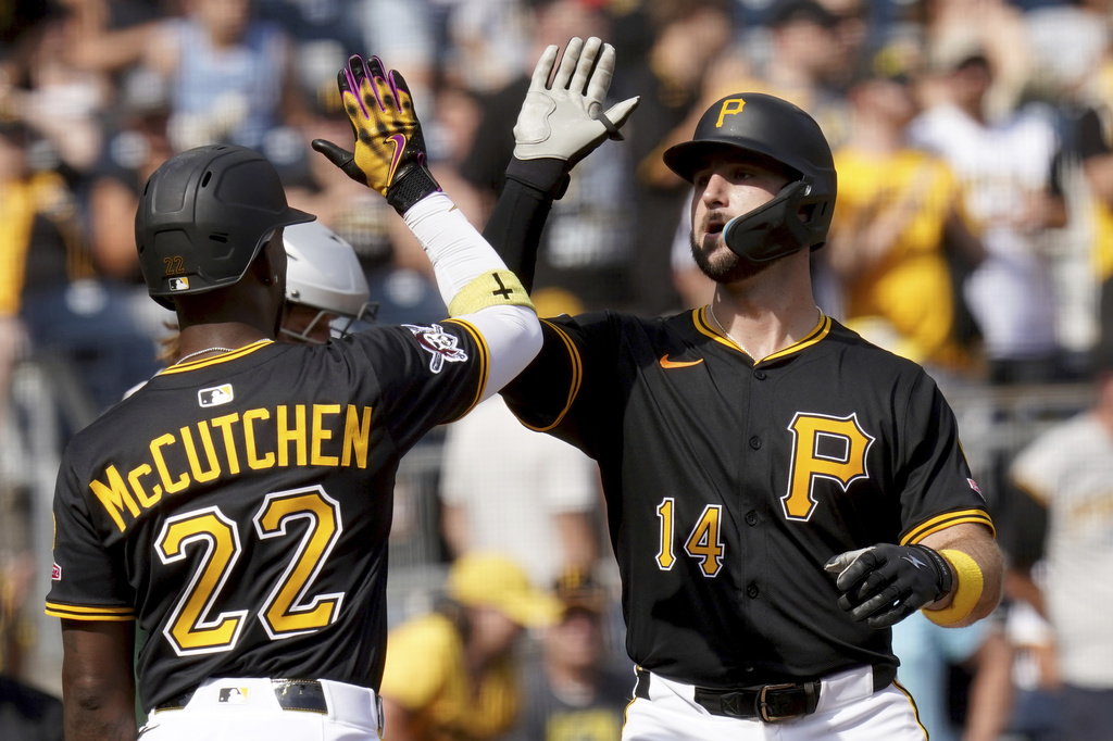 Pittsburgh Pirates' Joey Bart, right, is greeted by Andrew McCutchen, left, after hitting a three-run home run during the fifth inning of a baseball game against the Athletics, Sunday, Sept. 21, 2025, in Pittsburgh. (AP Photo/Matt Freed)
