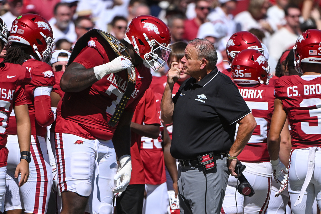 Arkansas coach Sam Pittman talks with offensive lineman Shaq McRoy (71) after McRoy ran for a touchdown against Notre Dame during the first half of an NCAA college football game Saturday, Sept. 27, 2025, in Fayetteville, Ark. (AP Photo/Michael Woods)