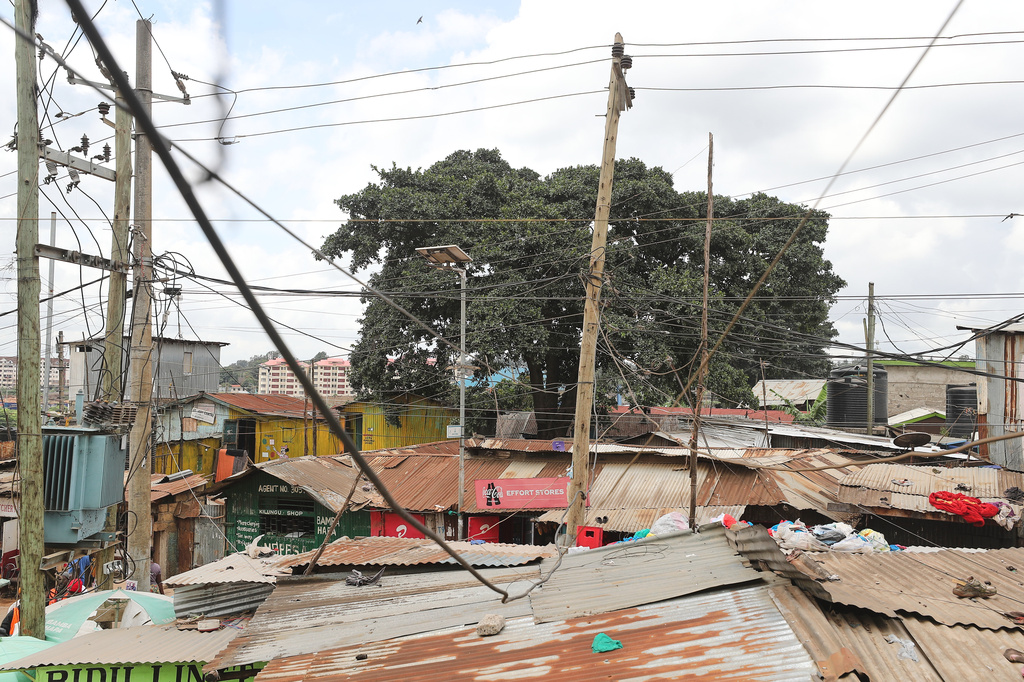 A view of electric wire poles and cables towering over the Kibera informal settlement in Nairobi, Kenya, Tuesday, March 31, 2026. (AP Photo/Henry Naminde)