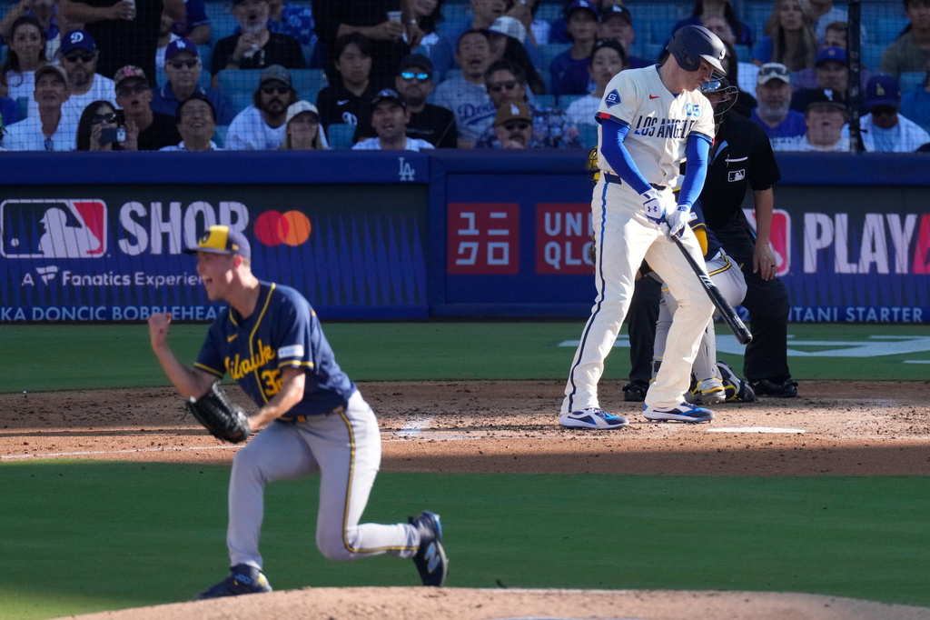 Milwaukee Brewers starting pitcher Jacob Misiorowski, left, celebrates after striking out Los Angeles Dodgers' Freddie Freeman with the bases loaded during the fifth inning of a baseball game Saturday, Aug. 15, 2026, in Los Angeles. (AP Photo/Mark J. Terrill)