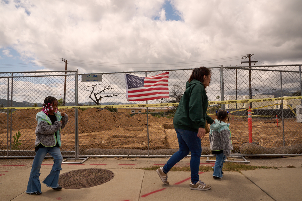Members of the congregation attend a groundbreaking service at the site of the burned Fountain of Life Nazarene Church to mark the beginning of its rebuilding in Altadena, Calif., April 26, 2026. (AP Photo/Damian Dovarganes)