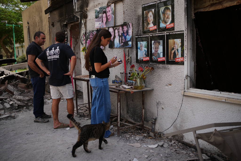 People visit the burnt house of Siman Tov family where all five family members were killed during the Hamas attack on Oct. 7, 2023, in Kibbutz Nir Oz, Israel, a day before Israel marks the two-year anniversary of the attack, Monday, Oct. 6, 2025. (AP Photo/Ohad Zwigenberg)