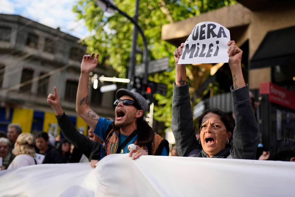 People protest outside the Movistar Arena ahead of President Javier Milei's presentation of his new book, "The Construction of the Miracle" in Buenos Aires, Argentina, Monday, Oct. 6, 2025. (AP Photo/Natacha Pisarenko)