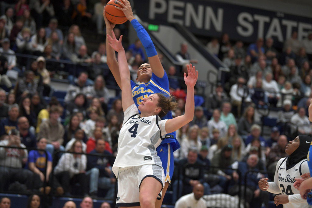 UCLA's Lauren Betts (51) takes a rebound away from Penn State's Maggie Mendelson (4) during the first half of an NCAA college basketball game Wednesday, Dec. 31, 2025, in State College, Pa. (AP Photo/Gary M. Baranec)