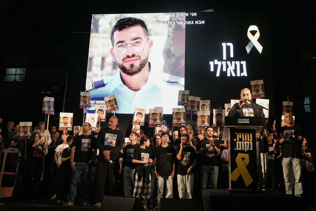 FILE - A photo of slain hostage Ran Gvili, whose remains are being held by Hamas in the Gaza Strip, is displayed during a rally calling for the return of the deceased hostages held in Gaza, in Tel Aviv, Israel, on Nov. 29, 2025. (AP Photo/Mahmoud Illean, File)