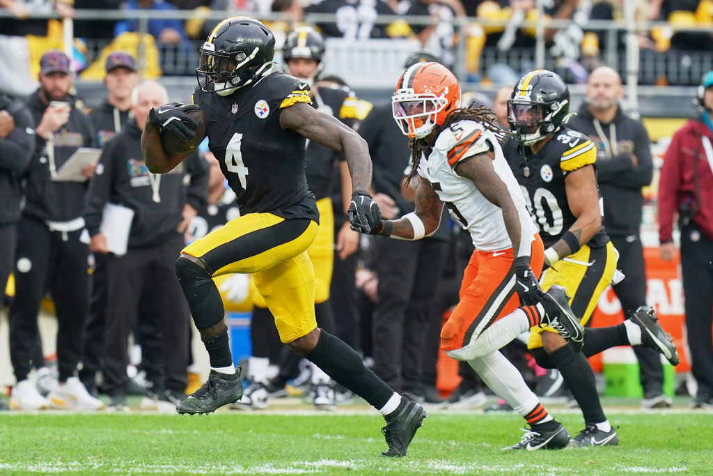 Pittsburgh Steelers wide receiver DK Metcalf (4) is pursued by Cleveland Browns safety Rayshawn Jenkins (5) in the second half of an NFL football game in Pittsburgh, Sunday, Oct. 12, 2025. (AP Photo/Matt Freed)