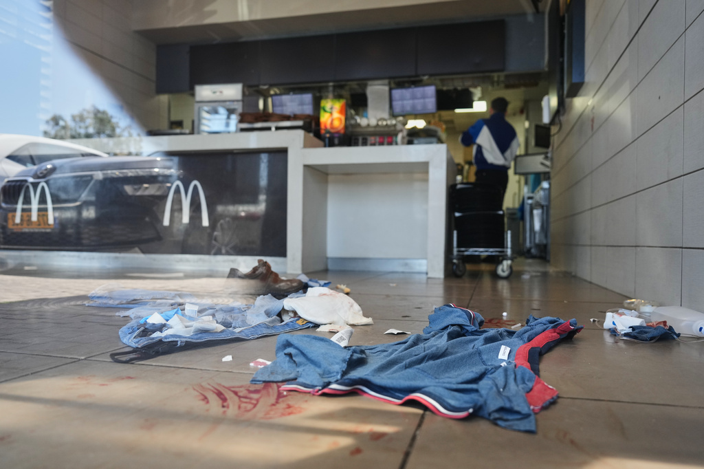 Blood stains are visible at the scene of what Israeli police say was a series of shooting attacks carried out by a Palestinian citizen of Israel in Kochav Yair, central Israel, Sunday, June 7, 2026. (AP Photo/Ariel Schalit)