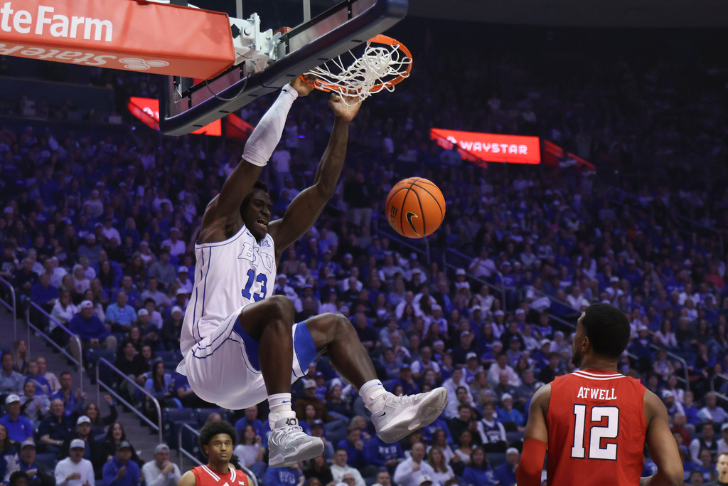 BYU center Keba Keita, left, dunks the ball against Texas Tech during the first half of an NCAA college basketball game, Saturday, March 7, 2026, in Provo, Utah. (AP Photo/Rob Gray)