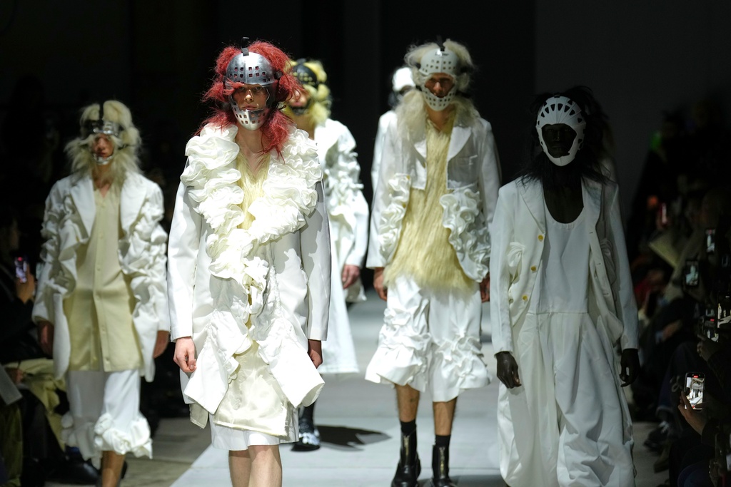 Models wear creations as part of the Comme des Garcons Fall/Winter 2026-2027 Men's collection presented in Paris, Friday, Jan. 23, 2026. (AP Photo/Aurelien Morissard)