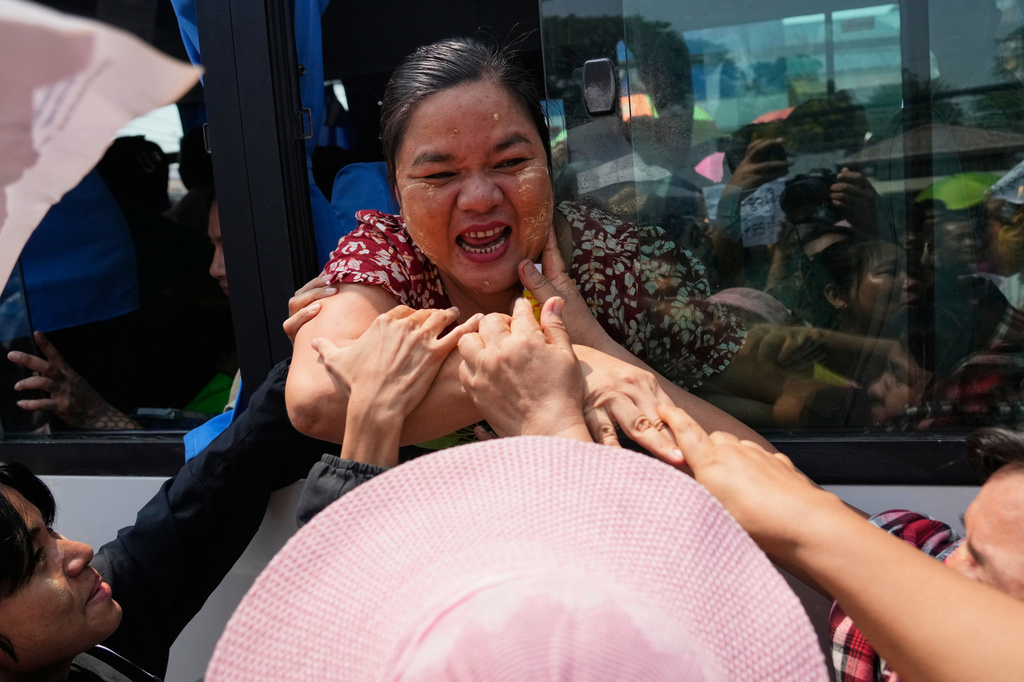 Released prisoners, in a bus, are welcomed by family members and colleagues after they left Insein Prison in Yangon, Myanmar, Friday, April 17, 2026, following Myanmar President's amnesty to mark the country's traditional new year. (AP Photo/Thein Zaw)