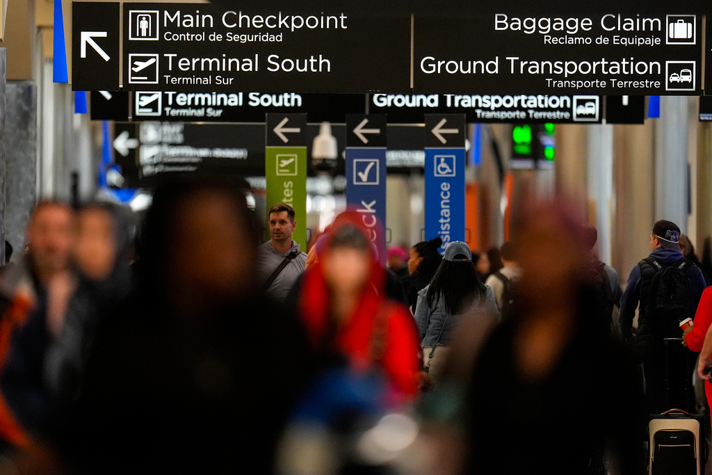 Passengers move inside Hartsfield-Jackson Atlanta International Airport, Friday, Nov. 7, 2025, in Atlanta. (AP Photo/Mike Stewart)