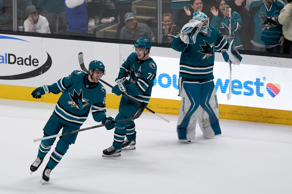 San Jose Sharks center Alexander Wennberg, left, celebrates after scoring a goal against the Anaheim Ducks with center Macklin Celebrini (71) and goaltender Yaroslav Askarov during the third period of an NHL hockey game in San Jose, Calif., Wednesday, April 1, 2026. (AP Photo/Jeff Chiu)