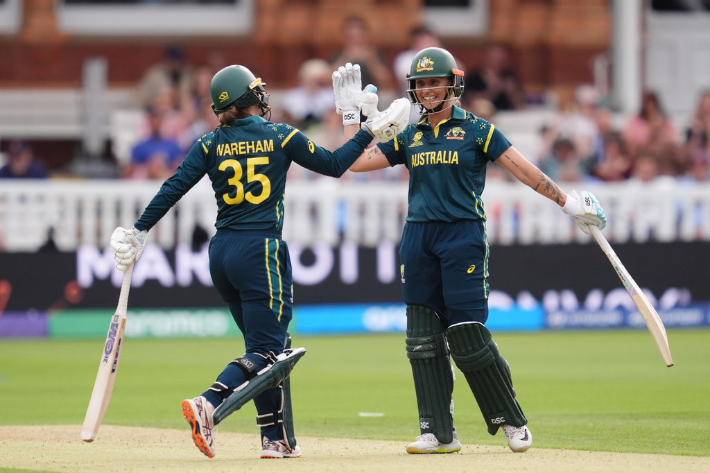 Australia's Georgia Wareham and Ashleigh Gardner celebrate the winning runs as they beat India during the Women's T20 World Cup cricket match between Bangladesh and South Africa at Lord's Cricket Ground, in London, Sunday June 28, 2026. (Adam Davy/PA via AP)