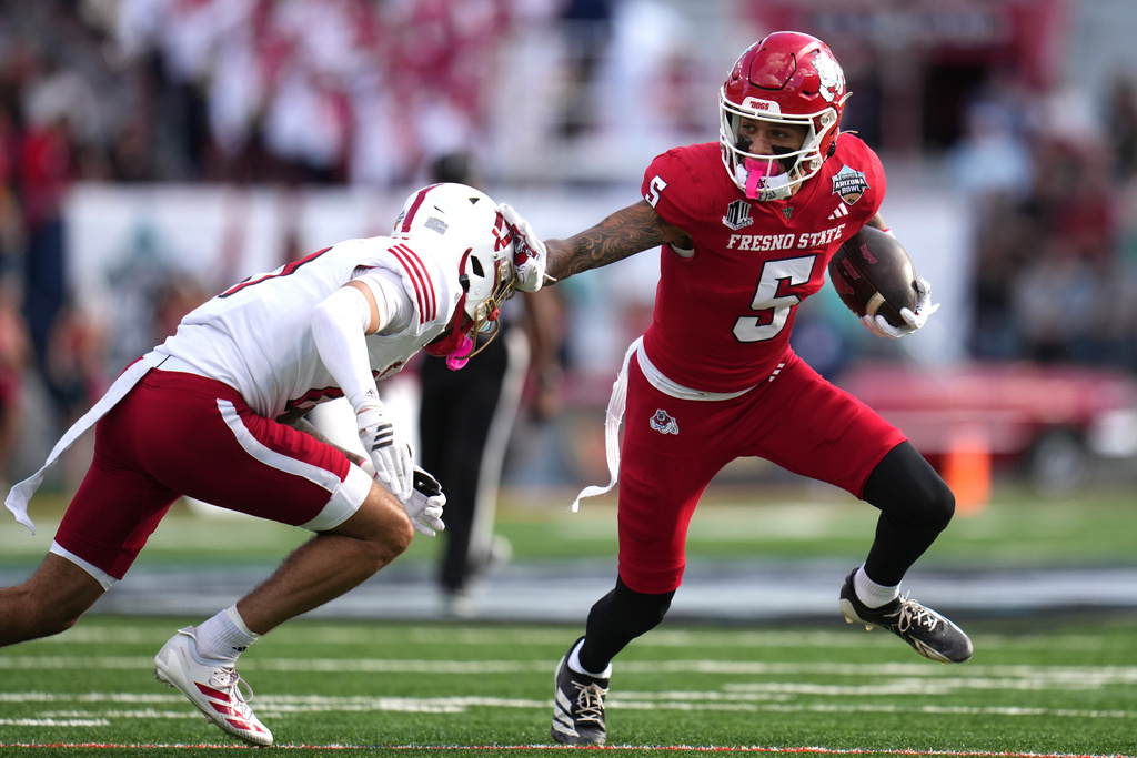 Fresno State wide receiver Josiah Freeman (5) stiff-arms Miami (Ohio) defensive back Kaleb Martin, left, in the first half of the Snoop Dogg Arizona Bowl NCAA college football game, Saturday, Dec. 27, 2025, in Tucson, Ariz. (AP Photo/Rick Scuteri)