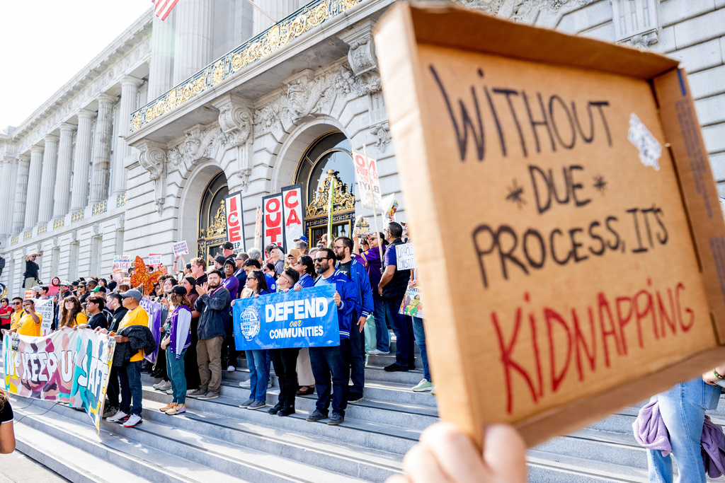 Protesters against U.S. Immigration and Customs Enforcement rally outside city hall on Thursday, Oct. 23, 2025, in San Francisco. (AP Photo/Noah Berger)
