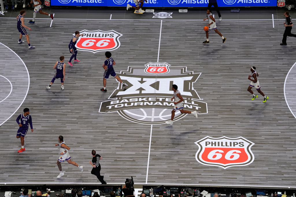 Players compete on an LED court as seen in this general view of the T-Mobile Center during the second half of an NCAA college basketball game between Kansas and TCU in the quarterfinal round of the Big 12 Conference tournament Thursday, March 12, 2026, in Kansas City, Mo. (AP Photo/Charlie Riedel)