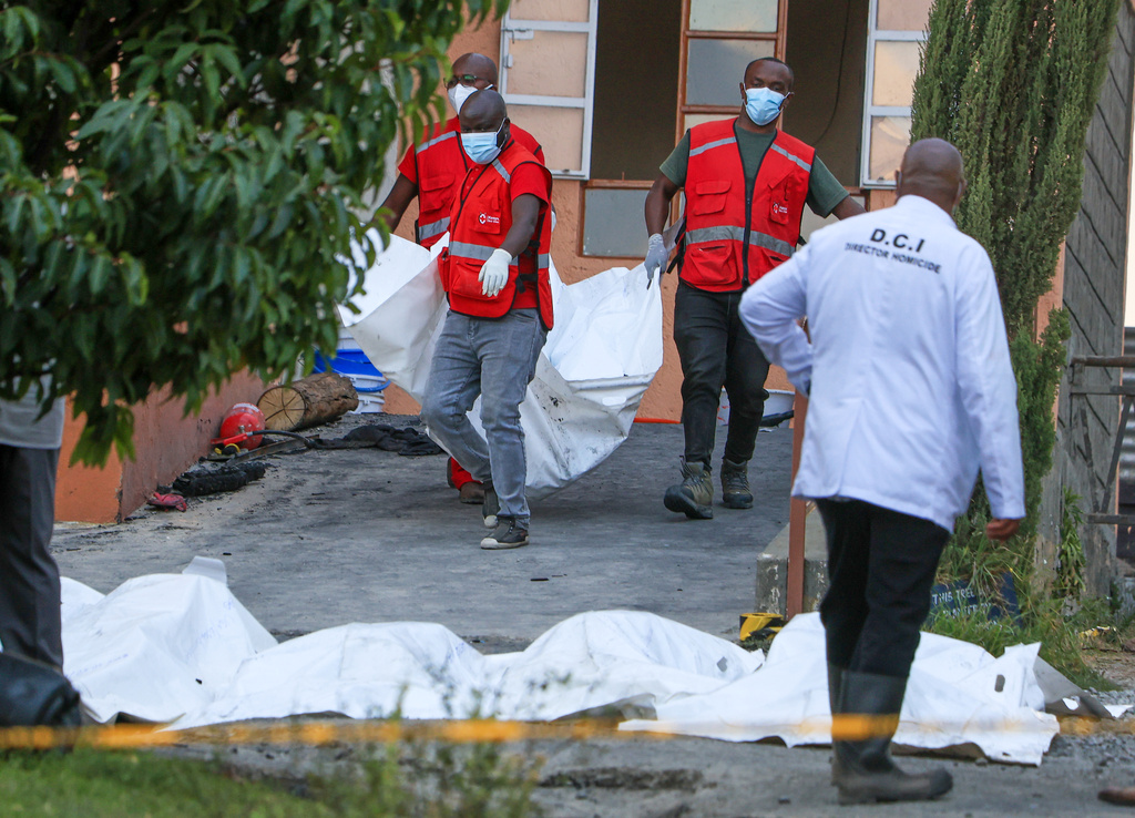 Red Cross members recover the bodies of students who died in the fire at the Utumishi Girls School in the Gilgil area, central Kenya, Thursday, May 28, 2026. (AP Photo/Andrew Kasuku)