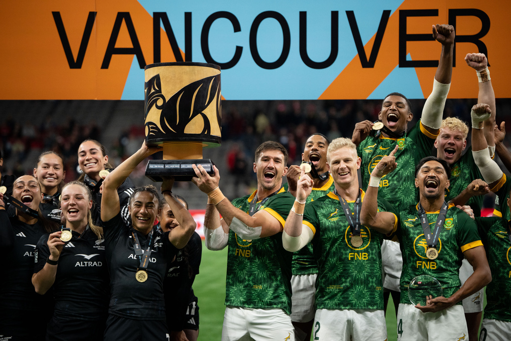 New Zealand team, left, and South Africa's team lift the Champion's Cup during the gold medal Vancouver Sevens rugby match, in Vancouver, British Columbia, Sunday, March 8, 2026. (Ethan Cairns/The Canadian Press via AP)