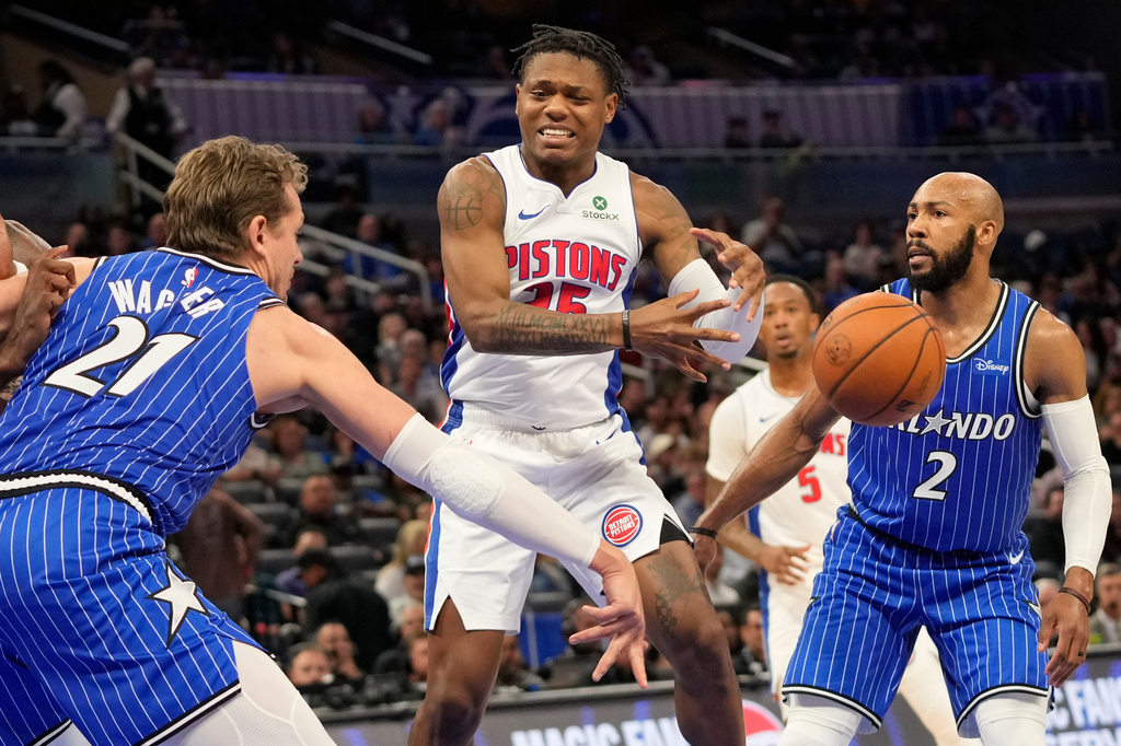 Detroit Pistons guard Marcus Sasser, center, loses control of the ball as he is defended by Orlando Magic forward Moritz Wagner (21) and guard Jevon Carter (2) during the first half of an NBA basketball game, Monday, April 6, 2026, in Orlando, Fla. (AP Photo/John Raoux)