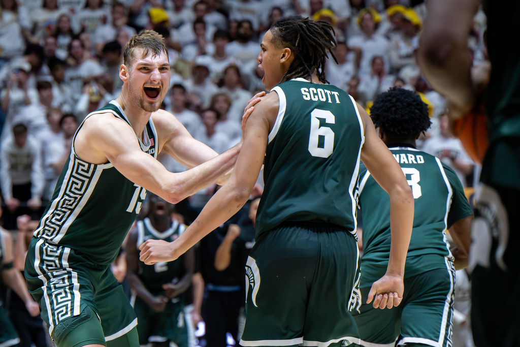 Michigan State center Carson Cooper, left, reacts with teammate forward Jordan Scott (6) after an NCAA college basketball game against Purdue, Thursday, Feb. 26, 2026, in West Lafayette, Ind. (AP Photo/Doug McSchooler)