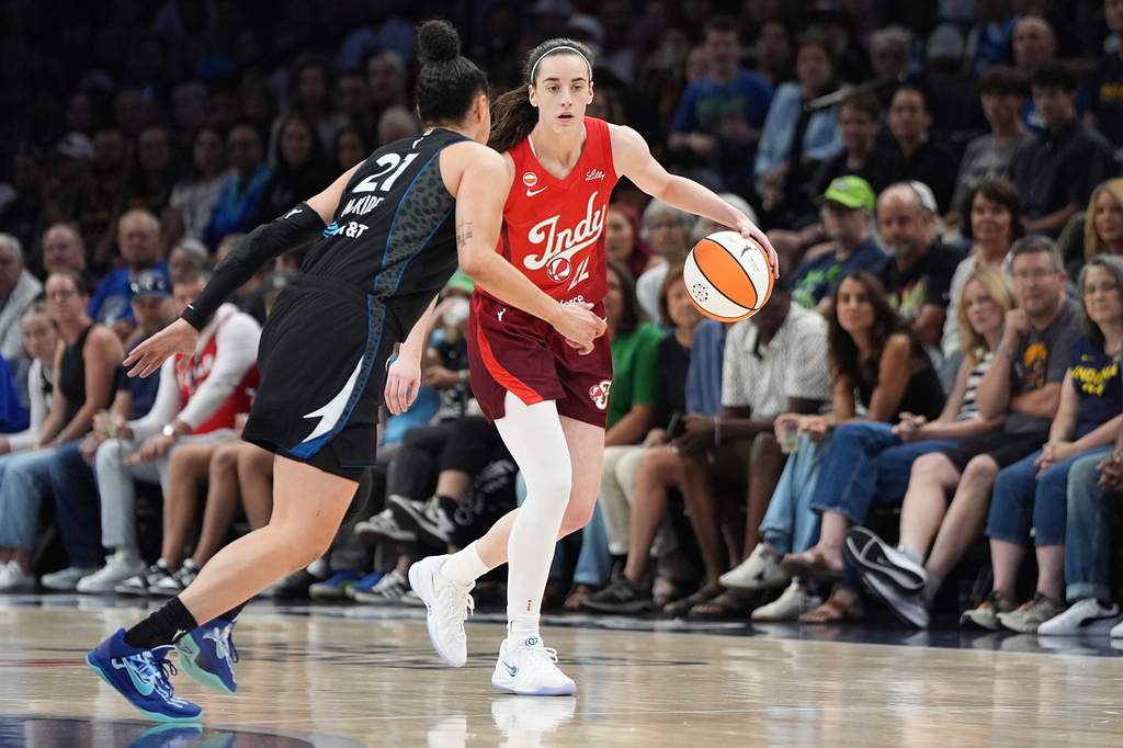 Indiana Fever guard Caitlin Clark, right,dribbles downcourt as Minnesota Lynx guard Kayla McBride (21) defends during the first half of a WNBA basketball game Sunday, Aug. 2, 2026, in Minneapolis. (AP Photo/Abbie Parr)