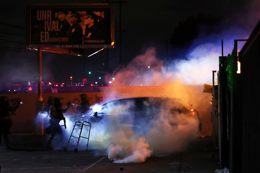 FILE - Law enforcement investigate a car with a person inside during a protest in Compton, Calif., June 7, 2025, after federal immigration authorities conducted operations. (AP Photo/Ethan Swope, file) FILE - Law enforcement investigate a car with a person inside during a protest in Compton, Calif., June 7, 2025, after federal immigration authorities conducted operations. (AP Photo/Ethan Swope, file)