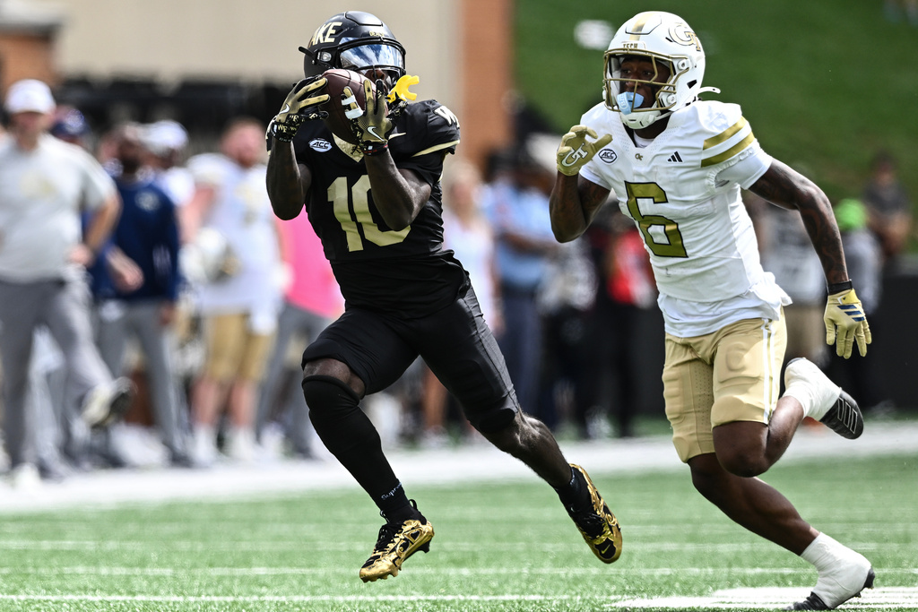 Wake Forest wide receiver Chris Barnes (10) catches a pass for a first down over Georgia Tech defensive back Rodney Shelley (6) during the first half of an NCAA college football game, Saturday, Sept. 27, 2025, in Winston-Salem, N.C. (AP Photo/Matt Kelley)