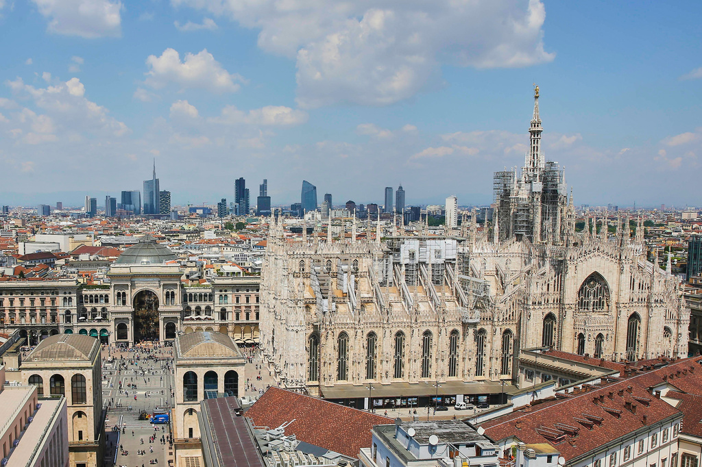 FILE - This photo shows Milan's CityLife district, including the city's tallest buildings, towering over historic architecture such as the Duomo cathedral at right, on Oct. 25, 2017. (AP Photo/Luca Bruno, File)