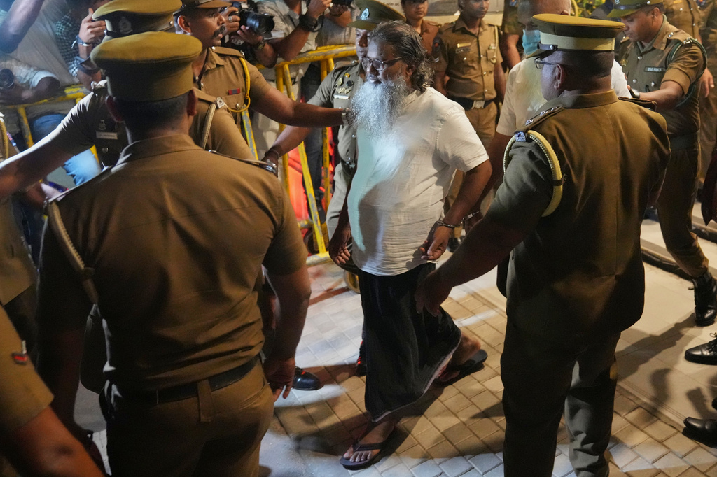 Unidentified men convicted for their involvement in the 2019 Easter bombings are escorted to a prison in Colombo, Wednesday, Sept. 23, 2026. (AP Photo/Eranga Jayawardena)