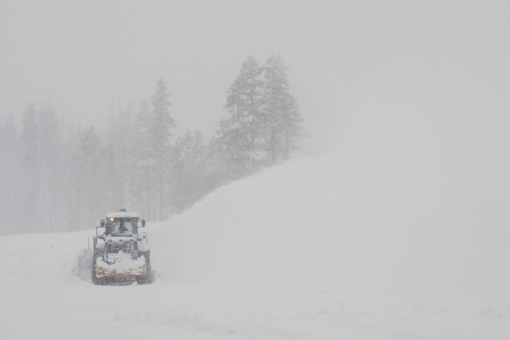 A road is cleared during a snow storm on Wednesday, Feb. 18, 2026 near Soda Springs, Calif. (AP Photo/Brooke Hess-Homeier)