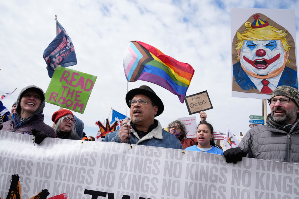 Minnesota Attorney General Keith Ellison, center, and others gather at Saint Paul College during a "No Kings" protest Saturday, March 28, 2026, in St. Paul, Minn. (AP Photo/Joe Scheller) ADDITION: Adds name of attorney general.