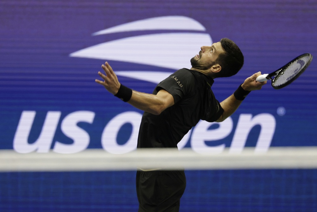 Novak Djokovic, of Serbia, returns a shot against Taylor Fritz, of the United States, during the quarterfinal round of the U.S. Open tennis championships, Tuesday, Sept. 2, 2025, in New York. (AP Photo/Adam Hunger)