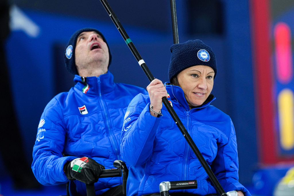 Italy's Orietta Berto, left, and Paolo Ioriatti compete against China during a wheelchair curling mixed doubles match at the 2026 Winter Paralympics in Cortina d'Ampezzo, Italy, Thursday, March 5, 2026. (AP Photo/Evgeniy Maloletka)