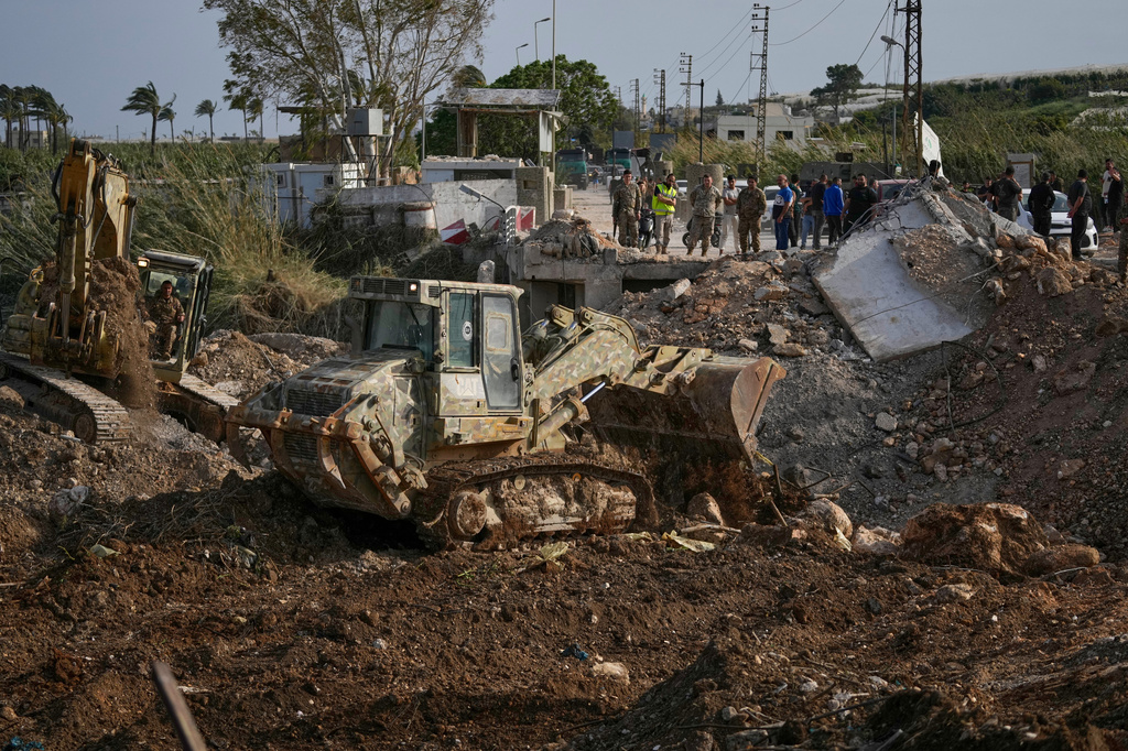 Lebanese army bulldozers reconstruct part of a destroyed bridge that was hit in an Israeli airstrike in Qasmiyeh near Tyre city, south Lebanon, to facilitate the return of displaced people to their villages following a ceasefire between Hezbollah and Israel, Friday, April 17, 2026. (AP Photo/Mohammed Zaatari)