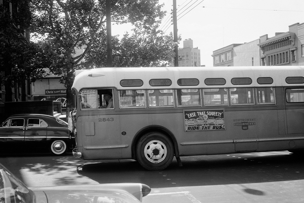 FILE - A man drives an empty bus through downtown Montgomery, Ala., April 26, 1956, during the Montgomery Bus Boycott. (AP Photo/Horace Cort, File)