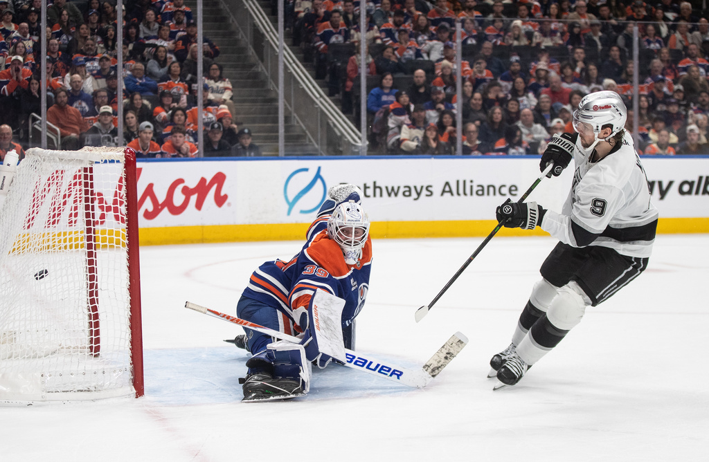 Los Angeles Kings' Adrian Kempe (9) scores on Edmonton Oilers goalie Connor Ingram (39) during a shootout of an NHL hockey game in Edmonton on Saturday, Jan. 10, 2026. (Jason Franson/The Canadian Press via AP)
