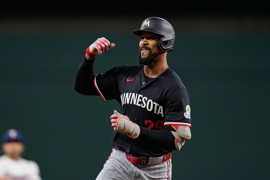 Minnesota Twins' Byron Buxton celebrate after hitting a solo home run in the first inning of a baseball game against the Texas Rangers Wednesday, Sept. 24, 2025, in Arlington, Texas. (AP Photo/Tony Gutierrez)