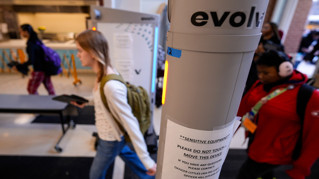 Students enter a security checkpoint at Midtown High School, Friday, March 6, 2026, in Atlanta. (AP Photo/Mike Stewart)