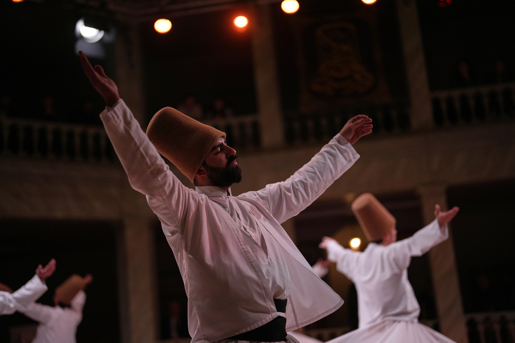 Whirling dervishes of the Mevlevi order perform during a Sheb-i Arus ceremony at Kasimpasa Mevlevihane in Istanbul, Turkey, Thursday, Dec. 11, 2025, to commemorate the death of 13th century Islamic scholar, poet and Sufi mystic Jalaladdin Rumi. (AP Photo/Francisco Seco)