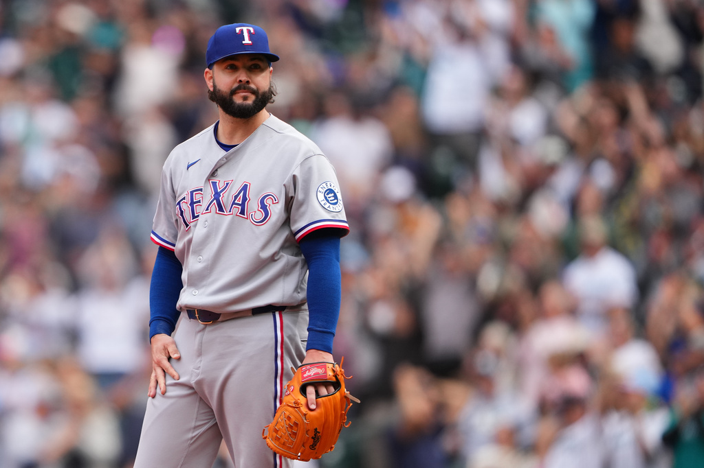 Texas Rangers relief pitcher Jakob Junis reacts after allowing a three-run home run against Seattle Mariners' Julio Rodríguez during the seventh inning of a baseball game, Thursday, Sept. 10, 2026, in Seattle. (AP Photo/Lindsey Wasson)
